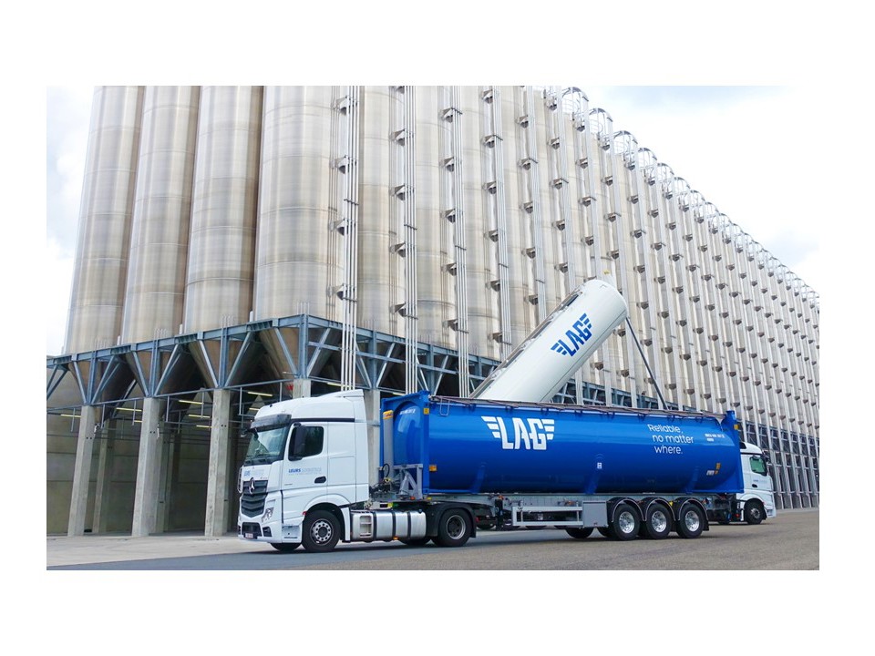 Loaded truck in a setting of an aluminium plant.