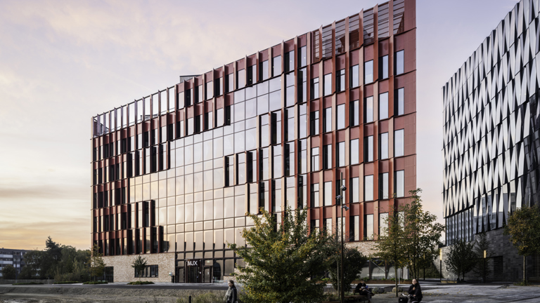 The red Speira aluminum façade of the Danish School of Media and Journalism.