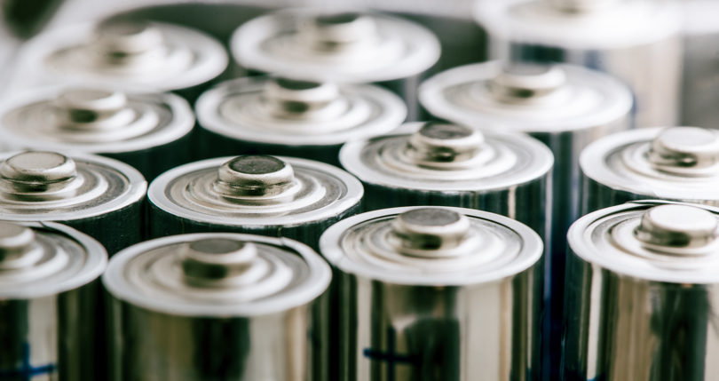 Aluminium components of batteries being stacked in a row.