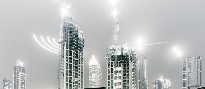 Skyscrapers and construction vehicles with different-looking lighting effects.