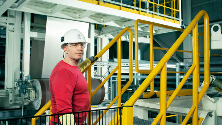 Speira employees at a yellow banister during production.