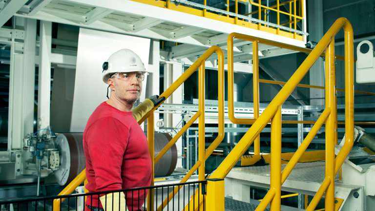 Speira employees at a yellow banister during production.