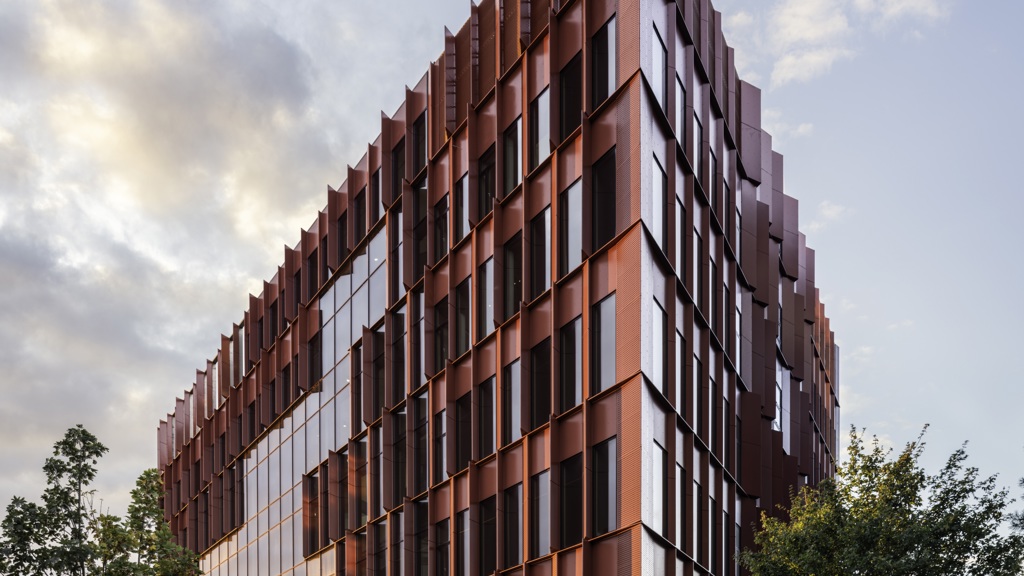 The red Speira aluminum façade of the Danish School of Media and Journalism.