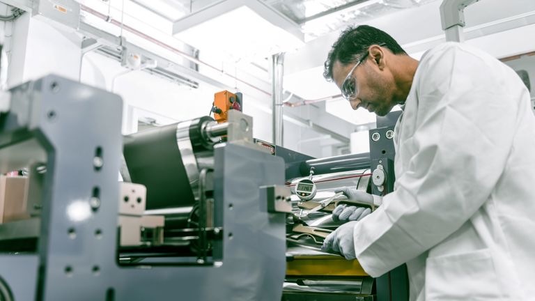 Laboratory worker inspects the material of Speira aluminum.