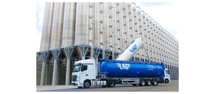 Loaded truck in a setting of an aluminium plant.