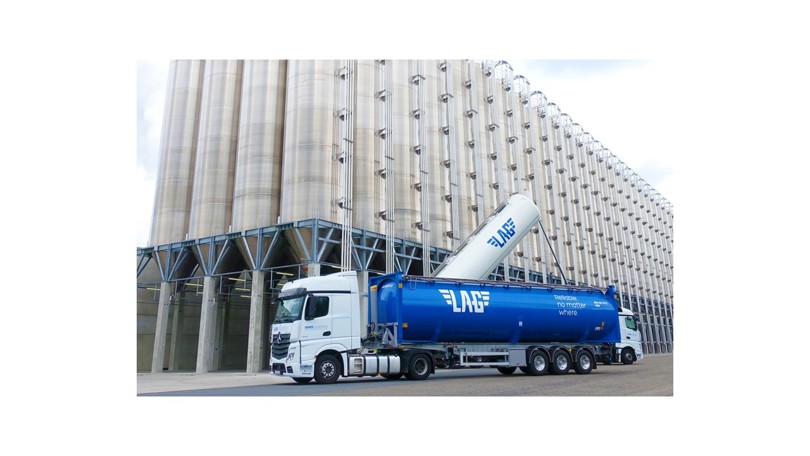 Loaded truck in a setting of an aluminium plant.