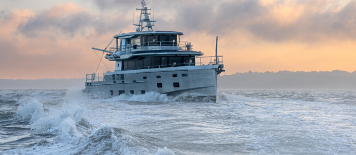 Arksen 85 Explorer Yacht on the sea in front of a sunrise.